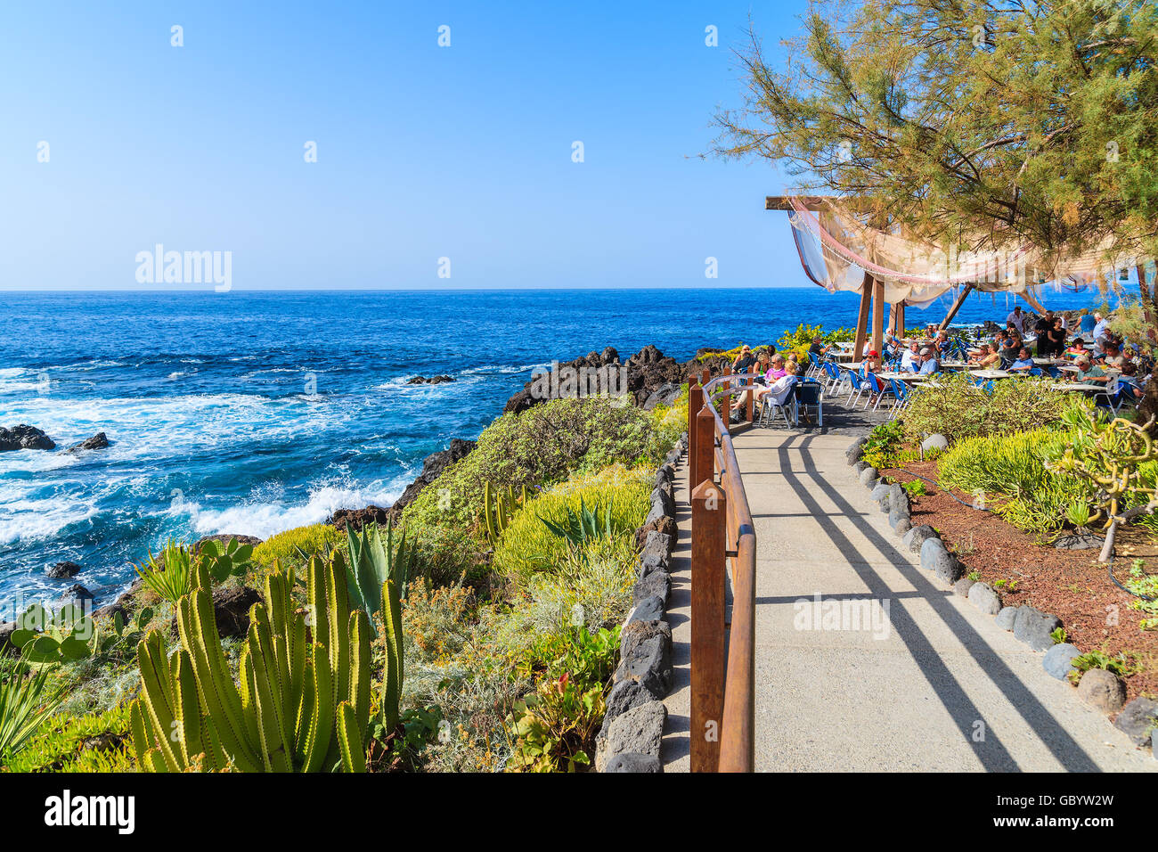 BUENAVISTA DEL NORTE, TENERIFE, NOV 15, 2015: walkway along Atlantic Ocean to restaurant on coast of Tenerife, Canary Islands, S Stock Photo