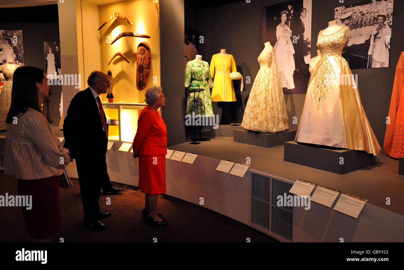 Britain's Queen Elizabeth II is shown around the Commonwealth exhibition at Buckingham Palace by Sir Hugh Roberts, Director of the Royal Collection and Assistant Curator Caroline De Guitaut. Stock Photo