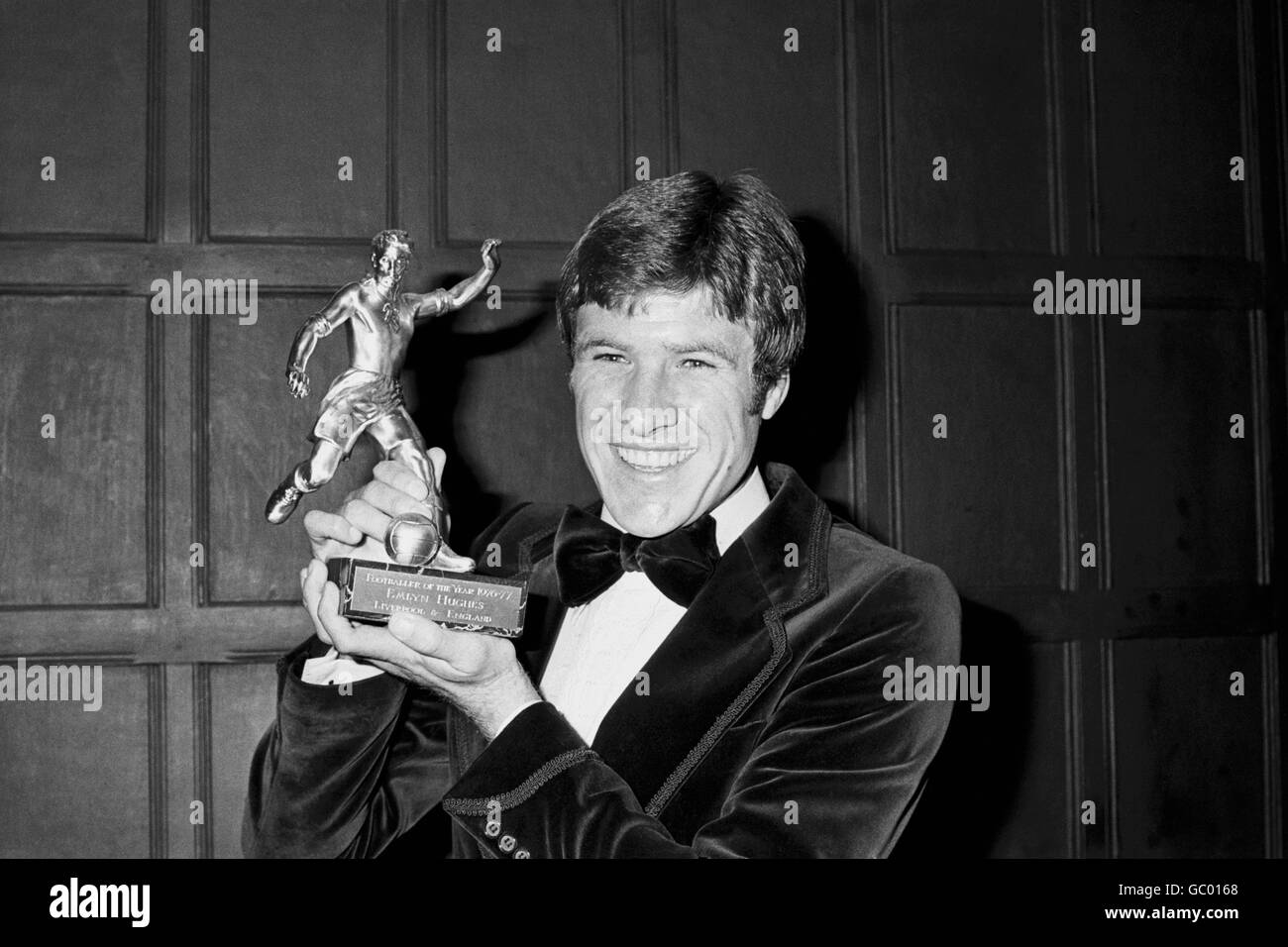 Liverpool's Emlyn Hughes shows off his 1976-77 Footballer of the Year trophy Stock Photo