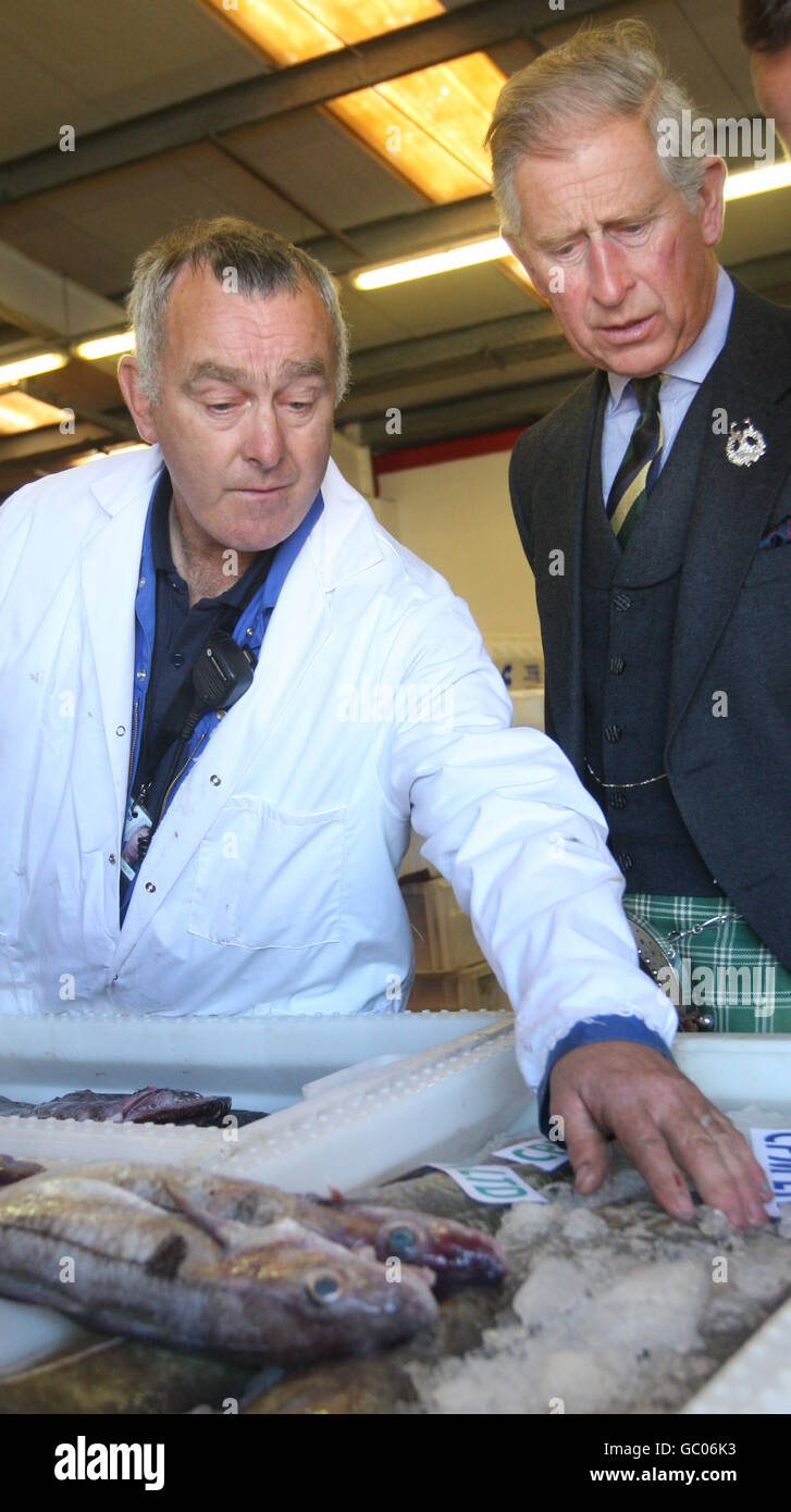 The Prince of Wales is shown a selection of fish by Hugh Campbell of the Scrabster Harbour Trust, during a visit to Scrabster. Stock Photo