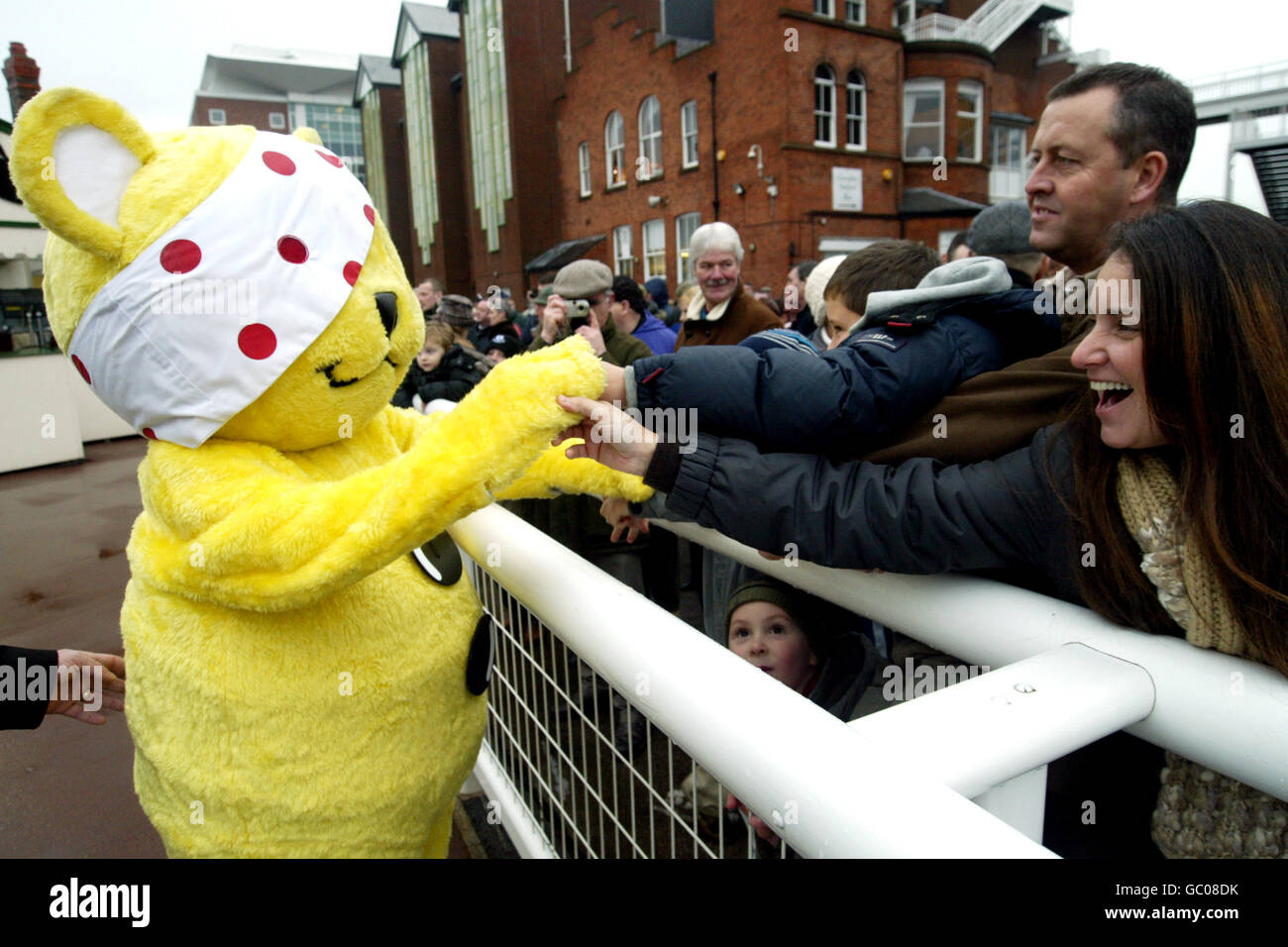 Pudsey bear greets race fans at aintree racecourse hi-res stock ...
