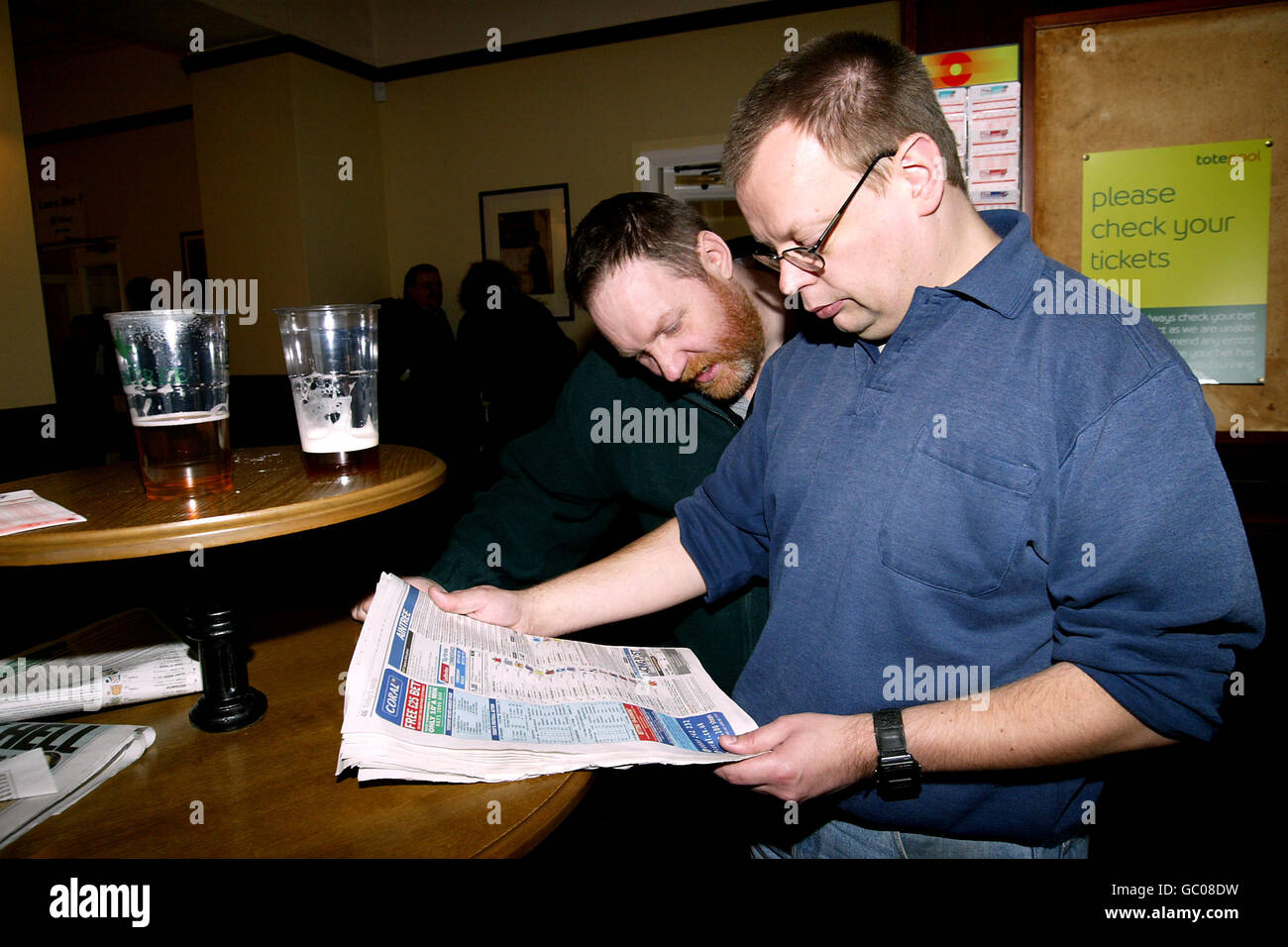 Racing fans check the form at aintree racecourse hi-res stock ...