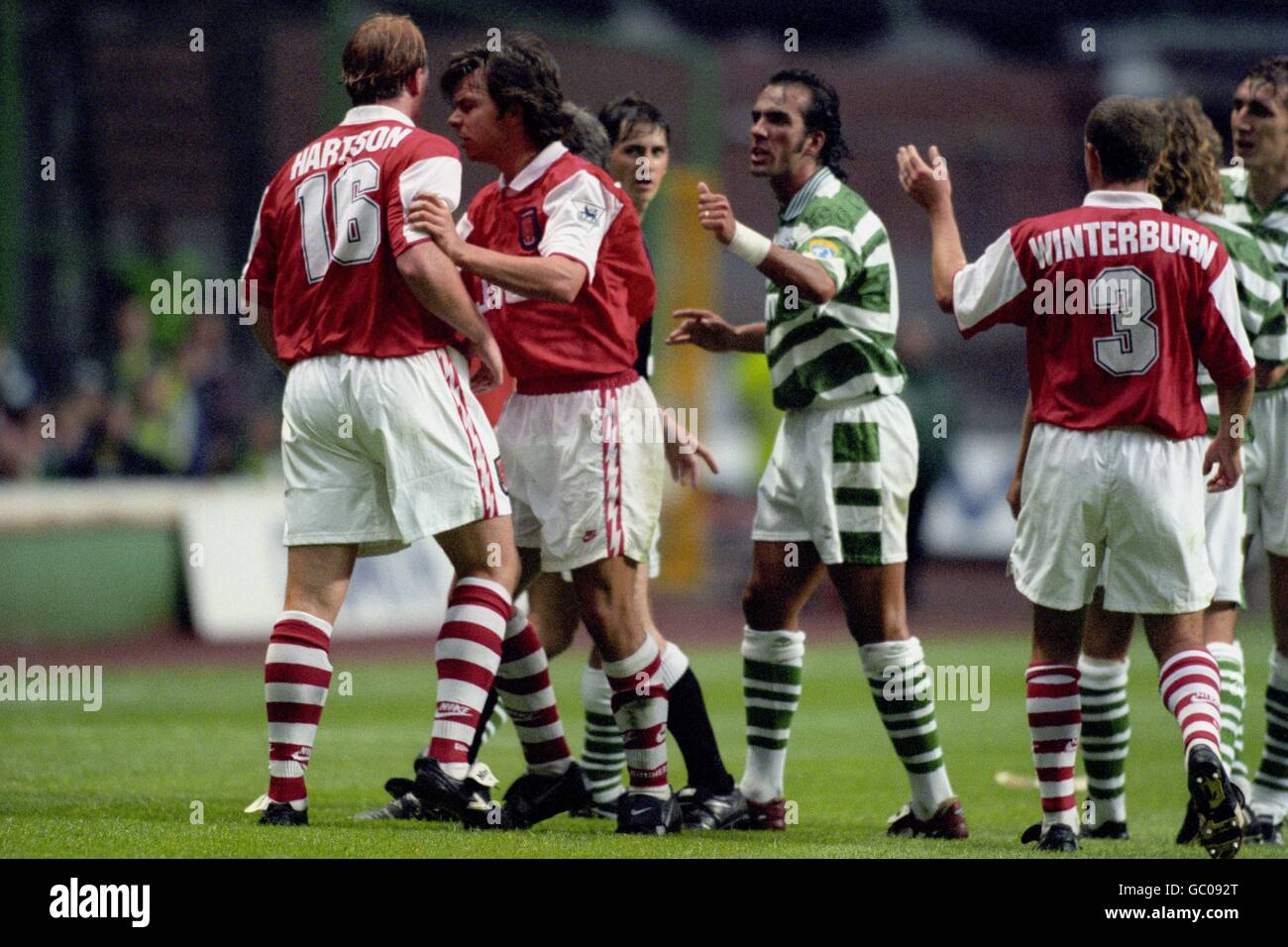 Arsenal's David Hillier has to push away team mate John Hartson as he tries to get at Celtic's Paolo Di Canio (c). Also picture for Arsenal is Nigel Winterburn (r). Stock Photo