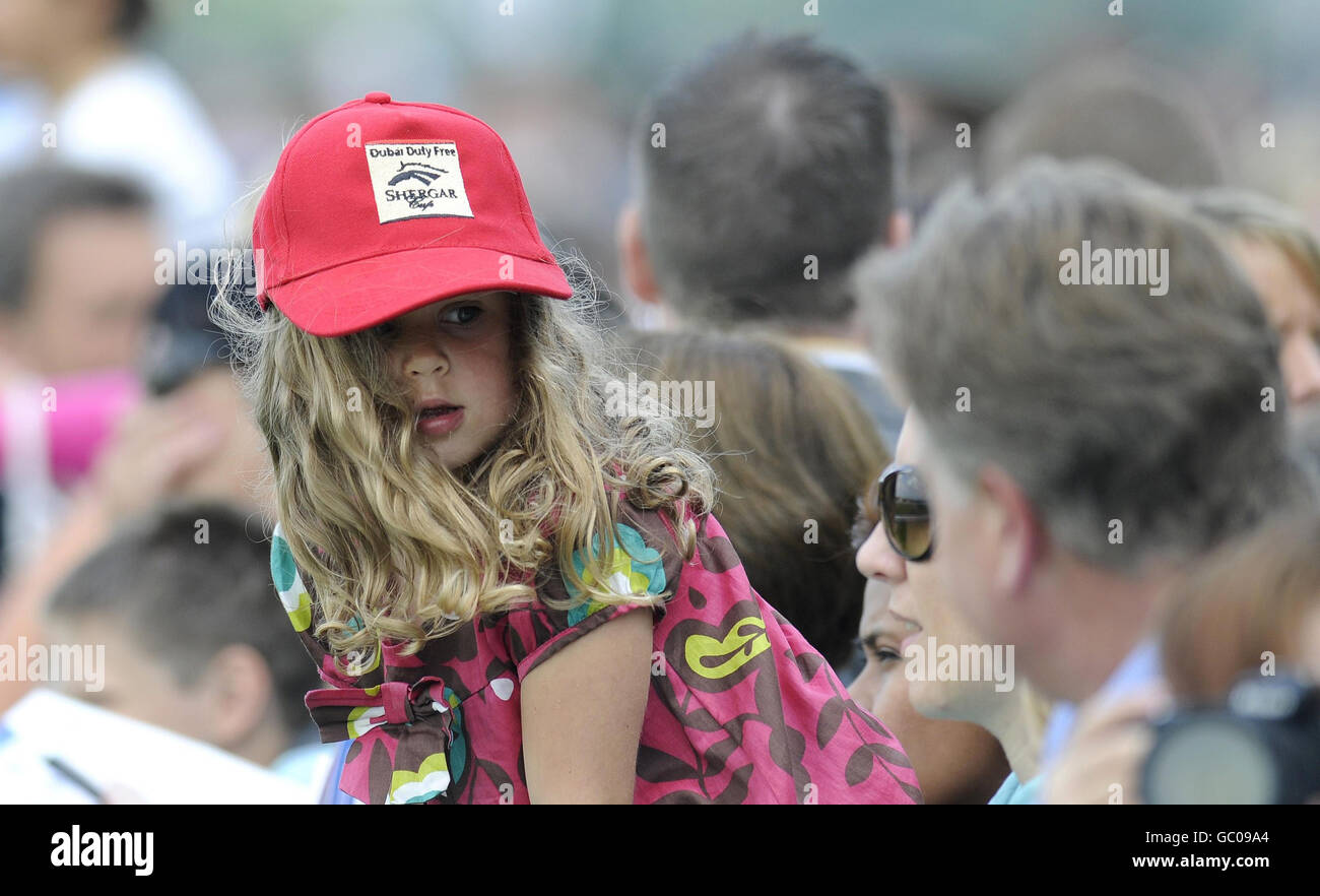 A young child enjoys a family day out during The Dubai Duty Free Shergar Cup Day at Ascot Racecourse, Berkshire. Stock Photo