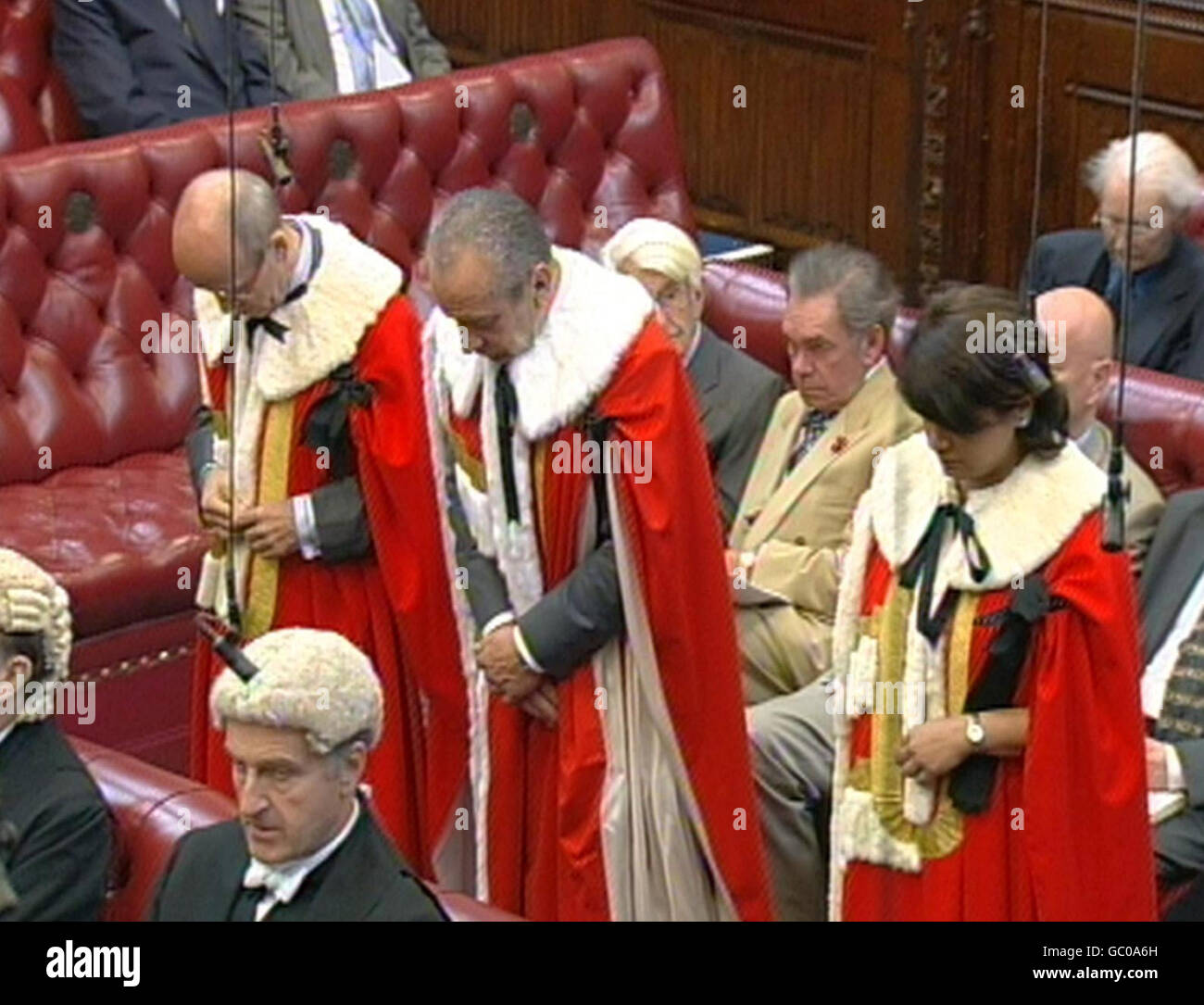 Sir Alan Sugar (centre) takes up his seat in the House of Lords, London, during a traditional ceremony. Stock Photo