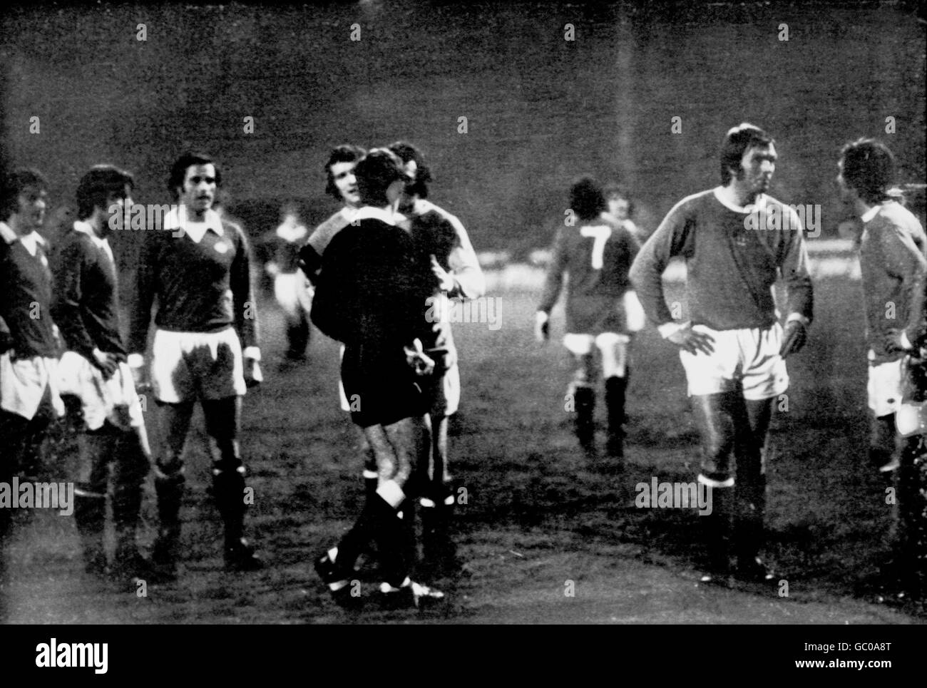 Manchester City's Mike Summerbee (third r) argues with referee Clive Thomas (fifth l) after the official sent off City's Mike Doyle (fourth l) and United's Lou Macari (out of pic), watched by United's Stewart Houston (l), Martin Buchan (second l) and George Graham (third l), and City's Alan Oakes (second r) and Dennis Tueart (r). The dismissed players refused to leave the field, prompting Thomas to take all the players off until the game could restart with both teams down to ten men Stock Photo