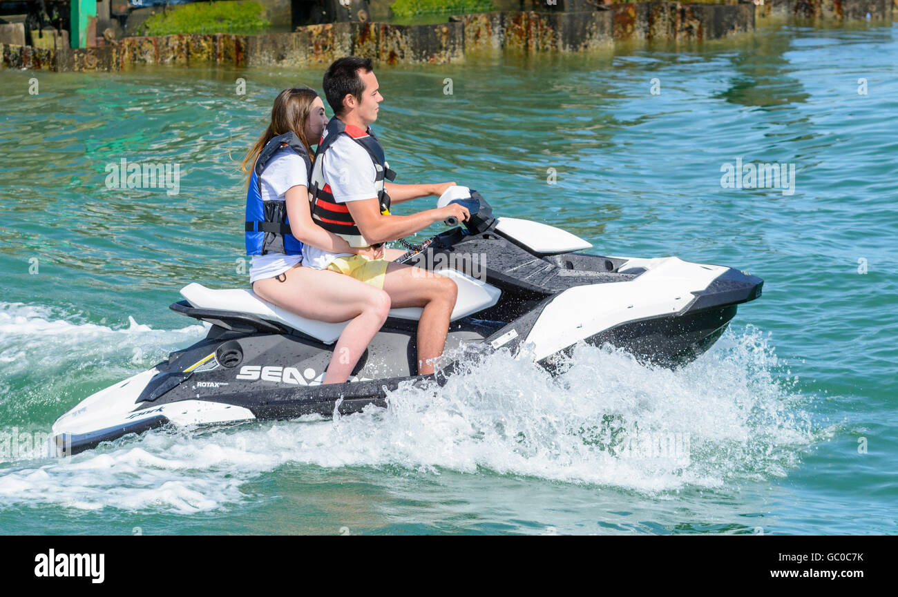 Couple riding on a jet ski on a river. Stock Photo