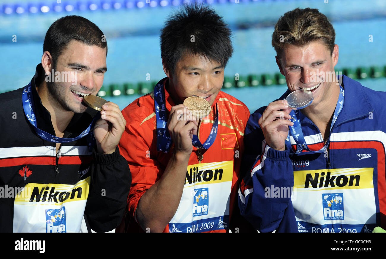 (left-right) Canada's Alexandre Despatie, China's Chong He and USA's Troy Dumais pose with there medals from the Men's 3m Springboard during the FINA World Swimming Championships in Rome, Italy. Stock Photo