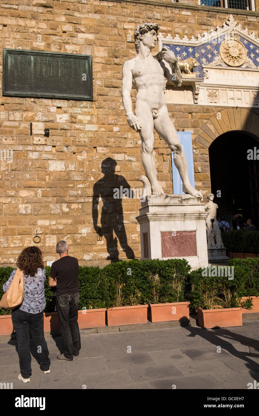 Copy of the David statue by Michaelangelo in the Piazza della Signore, and shadow cast on the wall behind, Florence, Tuscany, It Stock Photo