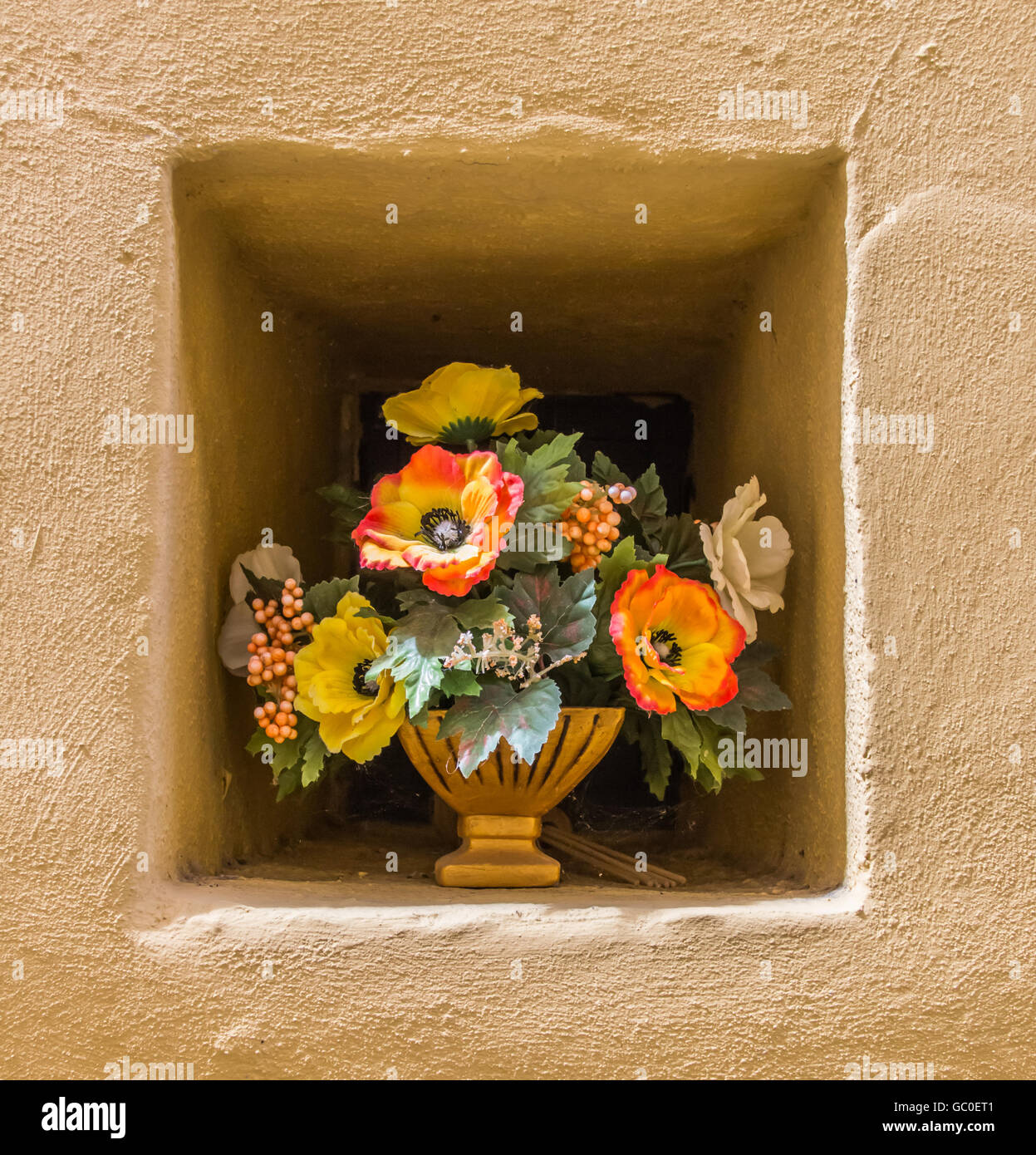 Yellow wall niche with a pot of flowers in Italy Stock Photo Alamy