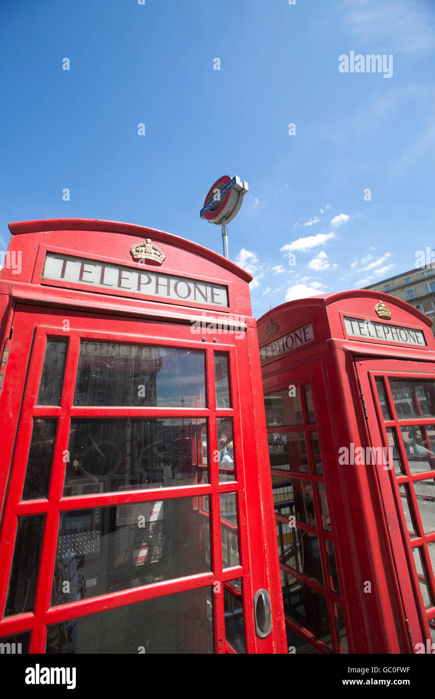 Red telephone boxes in a line outside Charing Cross train station, London, England, UK Stock Photo