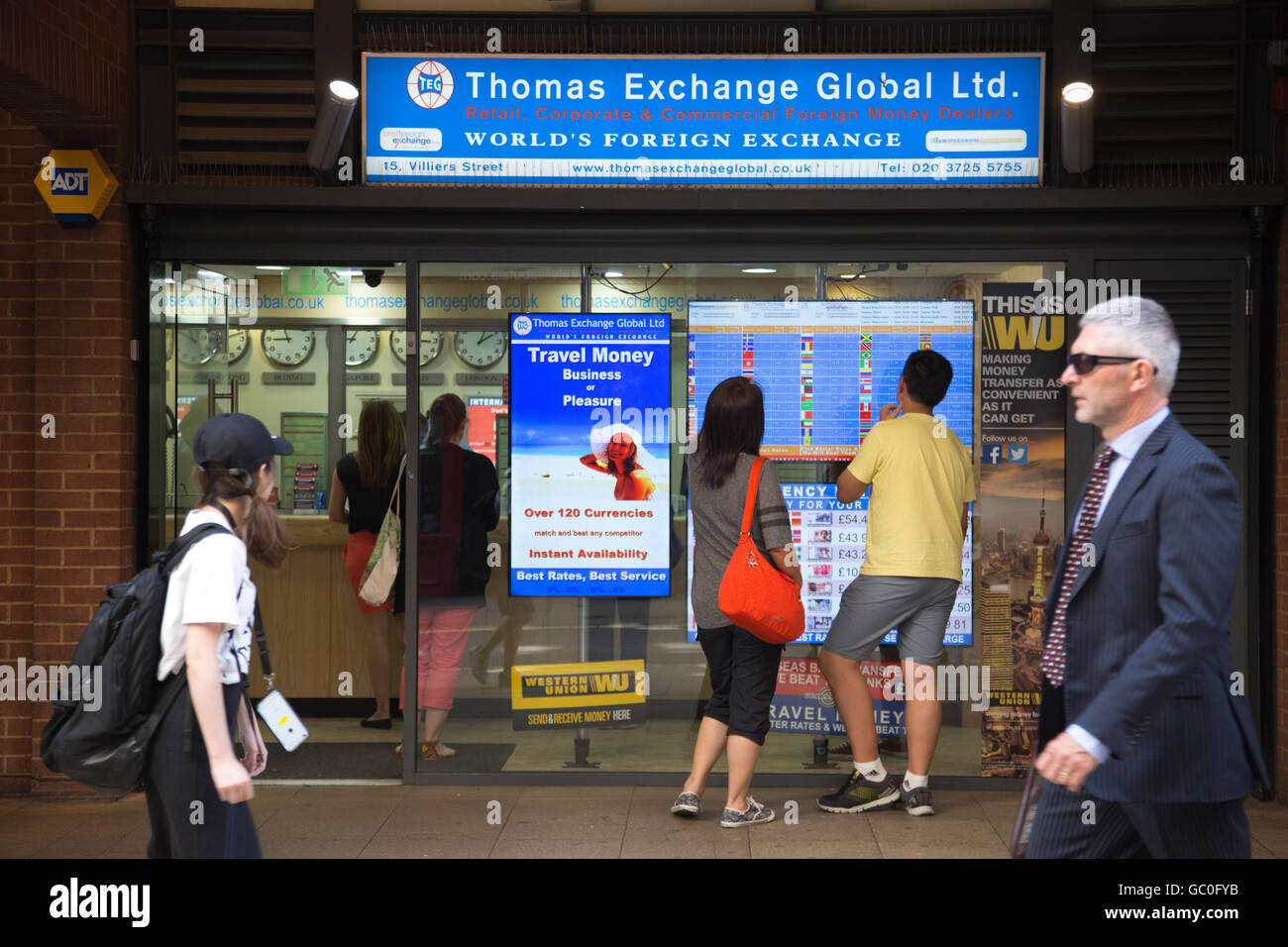 People queuing outside a Foreign Exchange bureau to get holiday currency in London as Sterling slides in value, UK Stock Photo