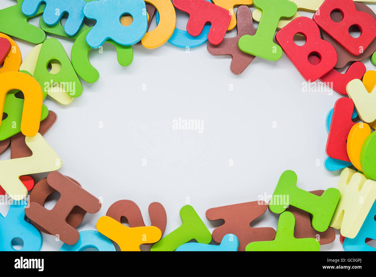 Colorful wooden character with white background space in the middle Stock Photo