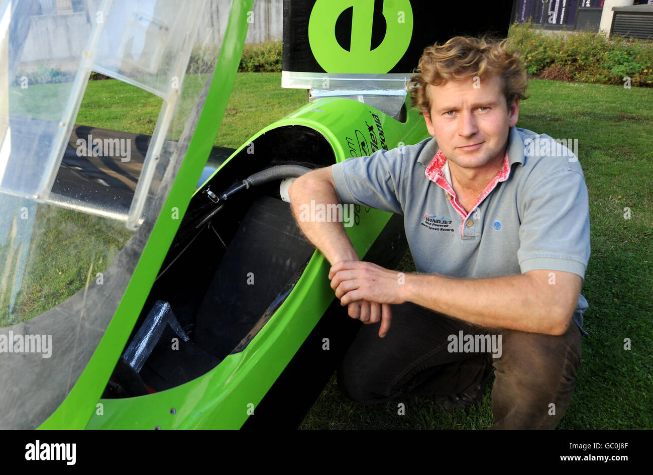 Engineer and record breaker Richard Jenkins poses beside the world's fastest wind-powered land vehicle, the Greenbird, at the Science museum in London. Stock Photo