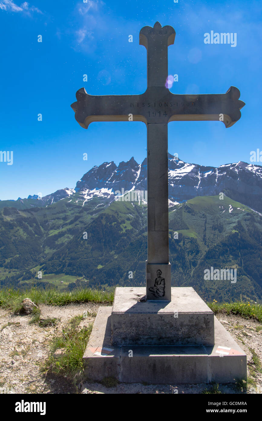 View of the alps from Portes du Soleil in Switzerland with a commemorative cross statue in the foreground Stock Photo