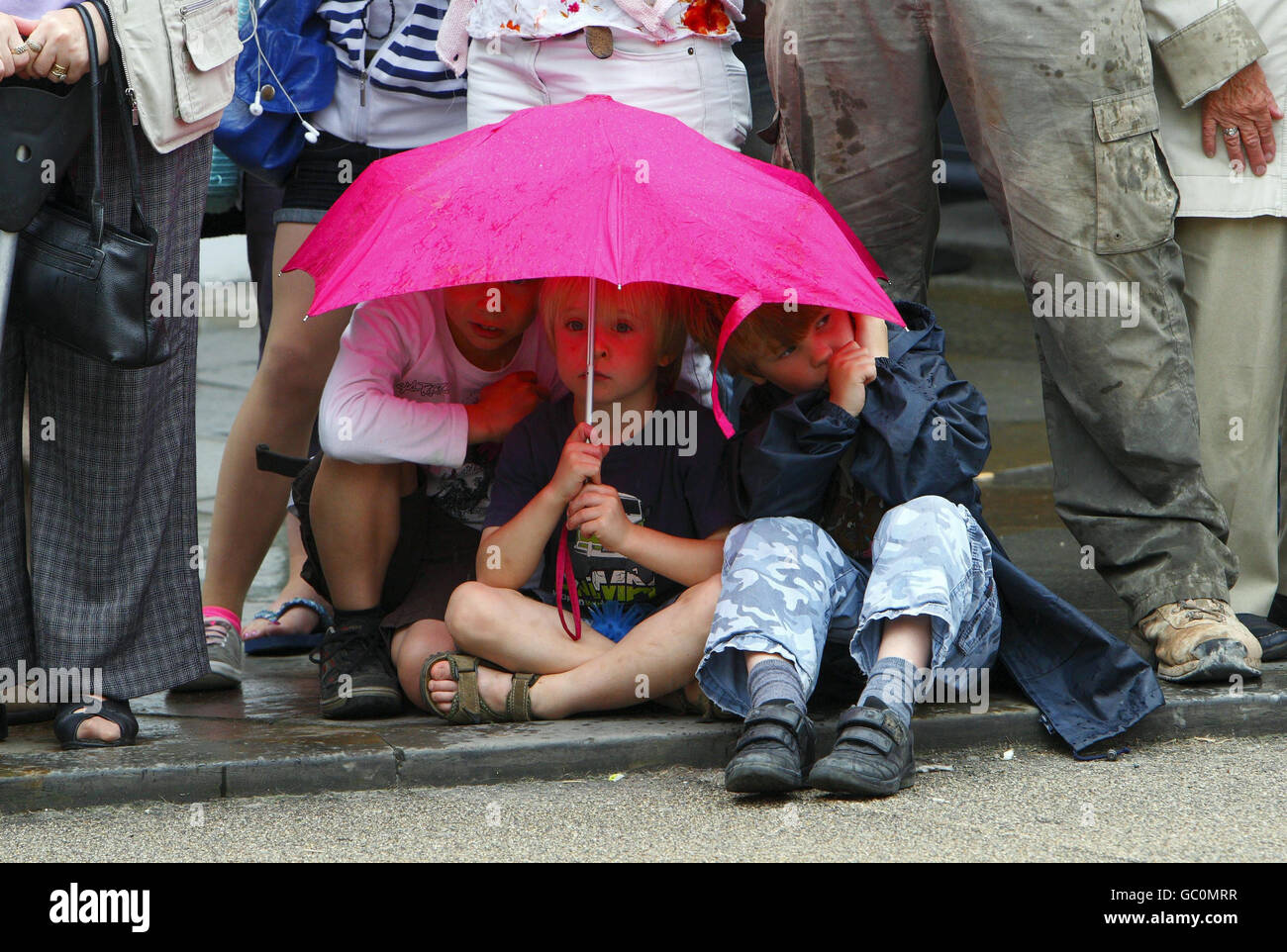 Children wait patiently in the rain for the hearse carrying the coffin of Harry Patch, the last man to fight in the First World War trenches, on the High Street in Wells, Somerset. Stock Photo