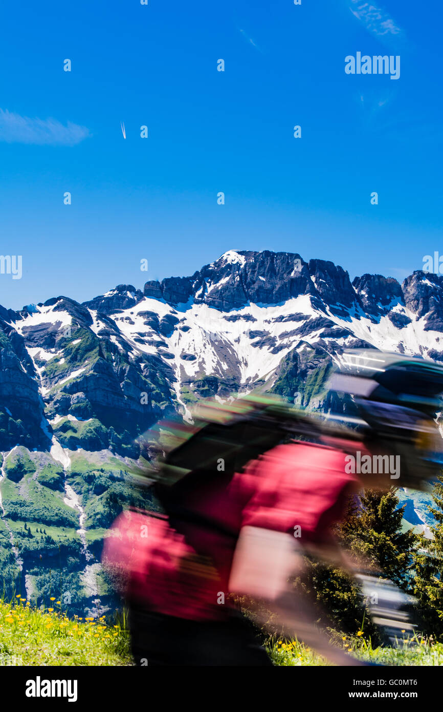A blurred image of a mountain biker riding downhill in Portes du Soleil in the Swiss Alps in Summer Stock Photo