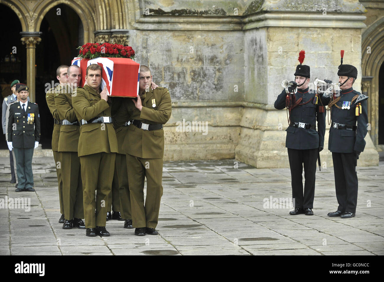 Buglers play the Last Post as the flag draped coffin of Harry Patch is carried out of Wells Cathedral by soldiers from The Rifles after the service in Somerset. Stock Photo