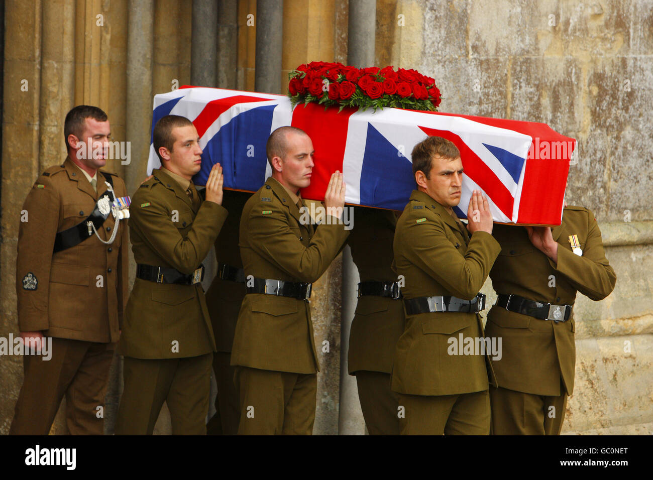 The flag draped coffin of Harry Patch is carried out of Wells Cathedral