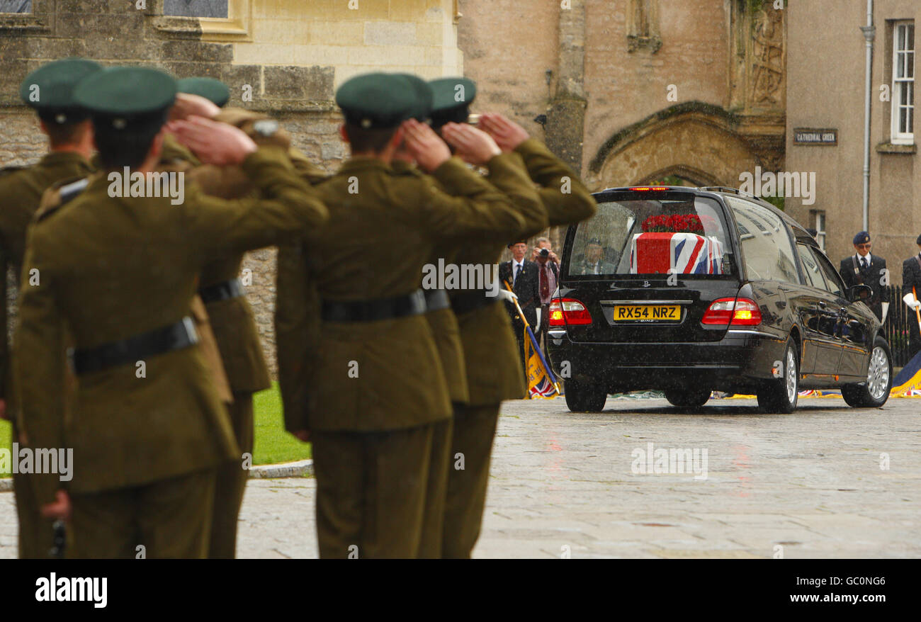 The pall bearers, soldiers from The Rifles, salute the coffin of Harry Patch, as it leaves Wells Cathedral in Somerset. Stock Photo