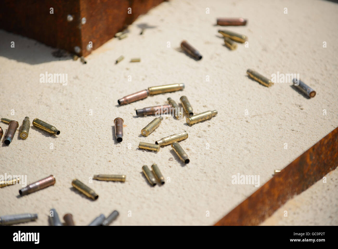 Bullets and spent cases on sand from hand gun Stock Photo