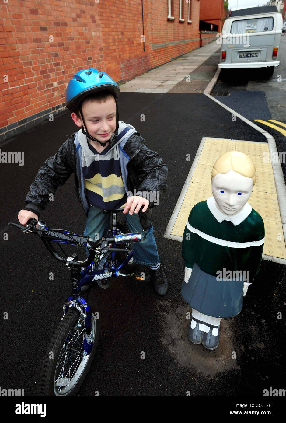 Bradley Ward, 8, from Leicester, with a bollard made to look like a child outside Avenue Primary School in Leicester. Stock Photo