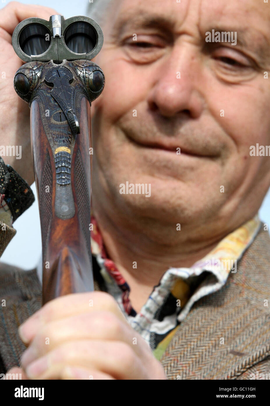 Gun Engraver Malcolm Appleby holds an unusual 12-bore 'Crocodile' gun by David McKay Brown. Malcolm engraved the gun to look like a crocodile and it is expected to be sold for between 25,000-35000 at an auction of Fine, Modern and Vintage Sporting Guns at Gleneagles Hotel on Monday August 24. Stock Photo