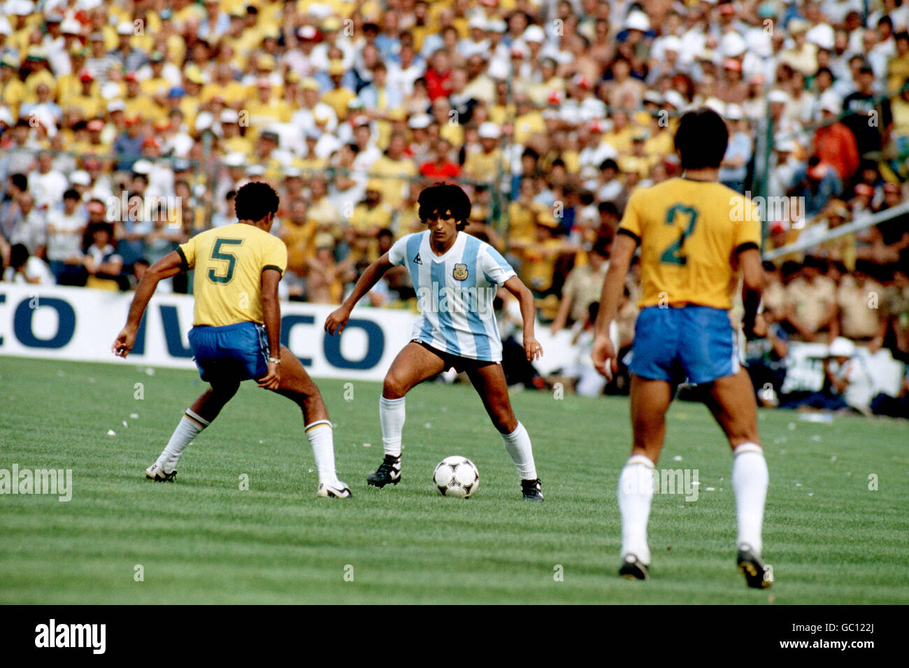 Soccer - World Cup Spain 82 - Group C - Brazil v Argentina. Argentina's Ramon Diaz (c) takes on Brazil's Toninho Cerezo (l) Stock Photo