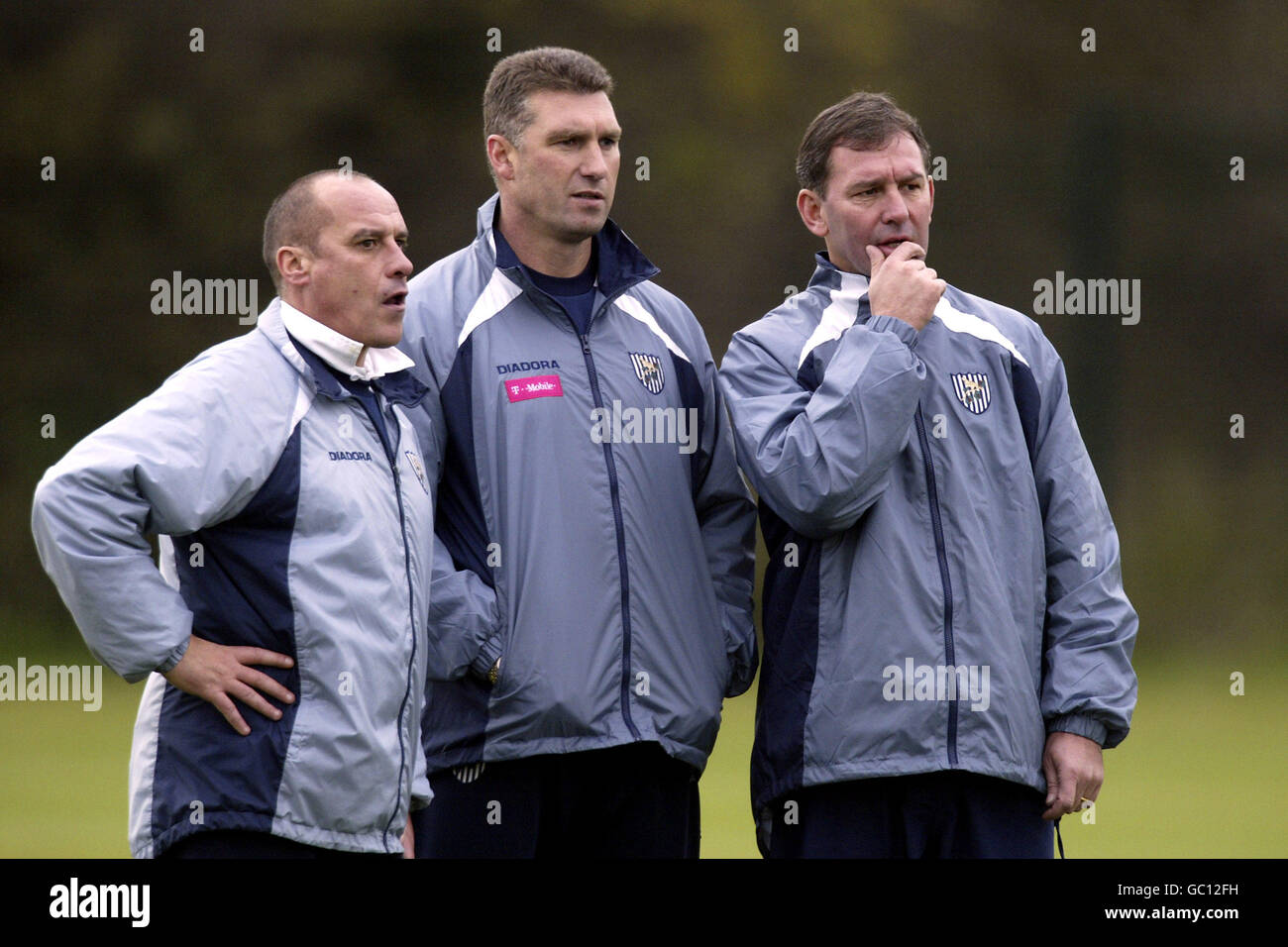 L-R: The new West Bromwich Albion managerial team of coach Gary Shelton, manager Bryan Robson and assistant Nigel Pearson run the rule over the players during training Stock Photo