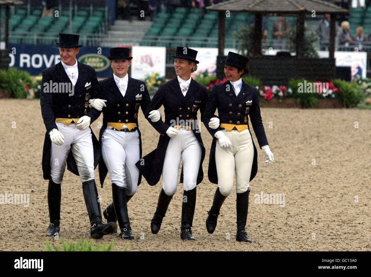 The Germany team walk to collect their bronze medals from the FEI