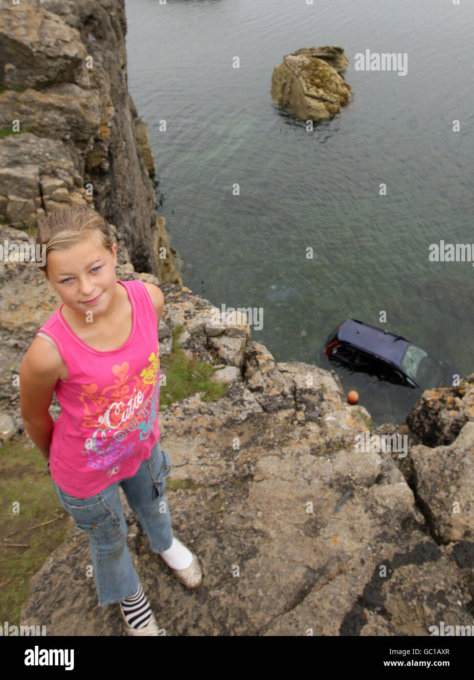 11-year-old Paige Dean, who cheated death after jumping from her grandfather's car (shown in sea) before it fell 50ft off a cliff edge and landed in the sea in Benllech, Anglesey. Stock Photo
