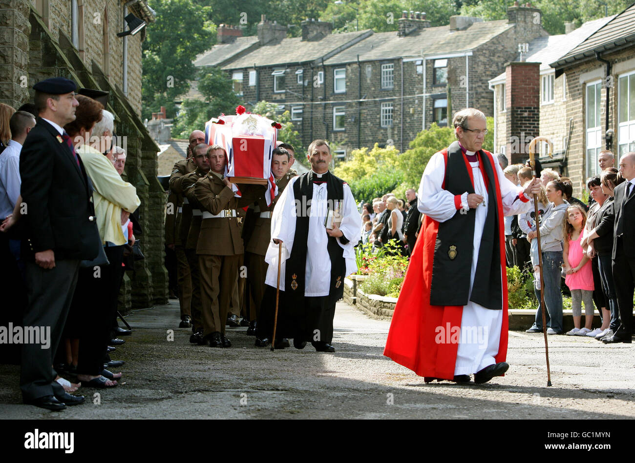 The coffin of Corporal Joseph Etchells, 22, is carried from St. George's Church in Mossley, Manchester. Stock Photo