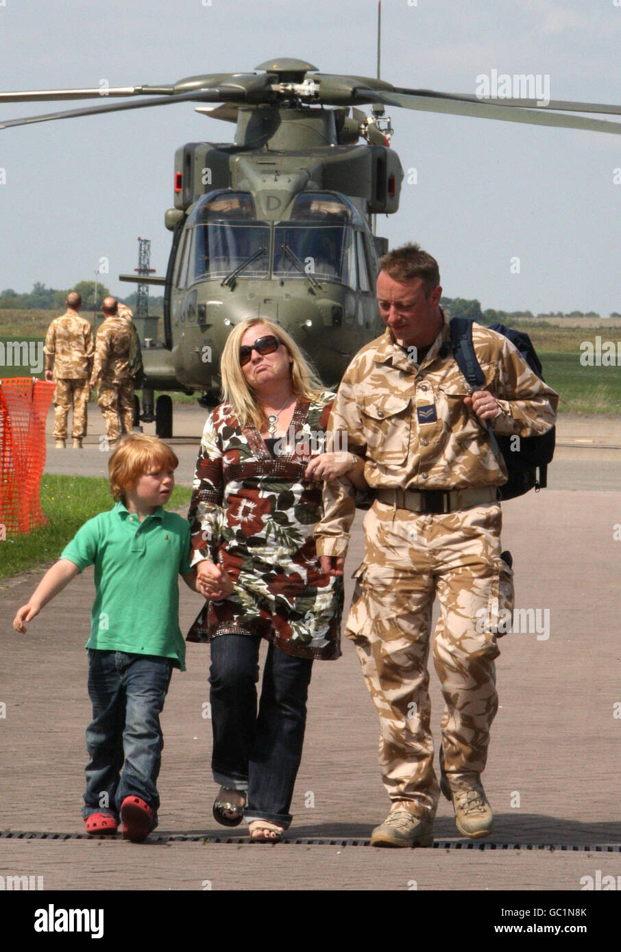 Cpl Sean Carrington is met by his wife Louise and son James, aged seven, as the last two Merlin helicopters return from Iraq to RAF Benson, in Oxfordshire. Stock Photo