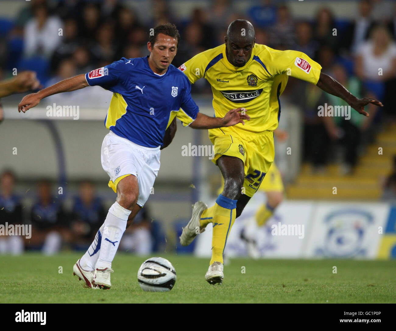 Cardiff City's Michael Chopra holds off Dagenham and Redbridge's Will Antwi (right) during the Carling Cup First Round match at the Cardiff City Stadium, Cardiff. Stock Photo