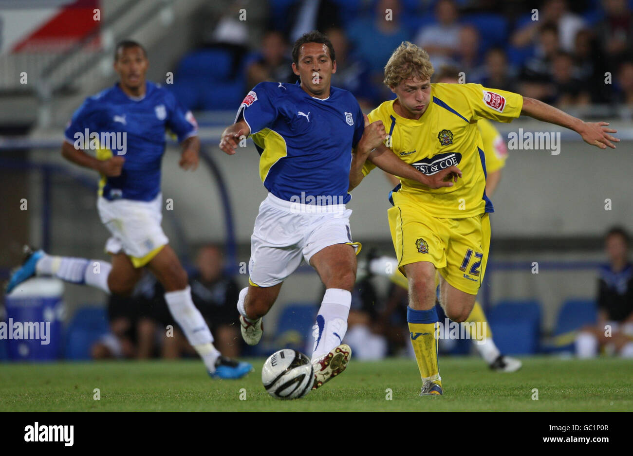 Cardiff City's Michael Chopra holds off Dagenham and Redbridge's Scott Griffiths (right) during the Carling Cup First Round match at the Cardiff City Stadium, Cardiff. Stock Photo