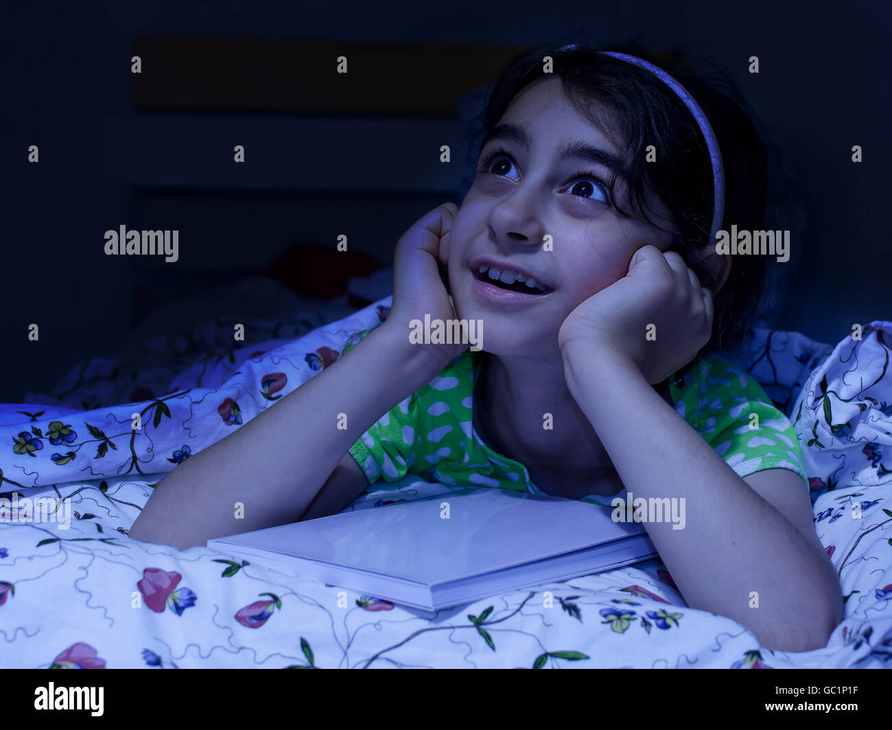 little girl laying in bed daydreaming,   before sleep Stock Photo