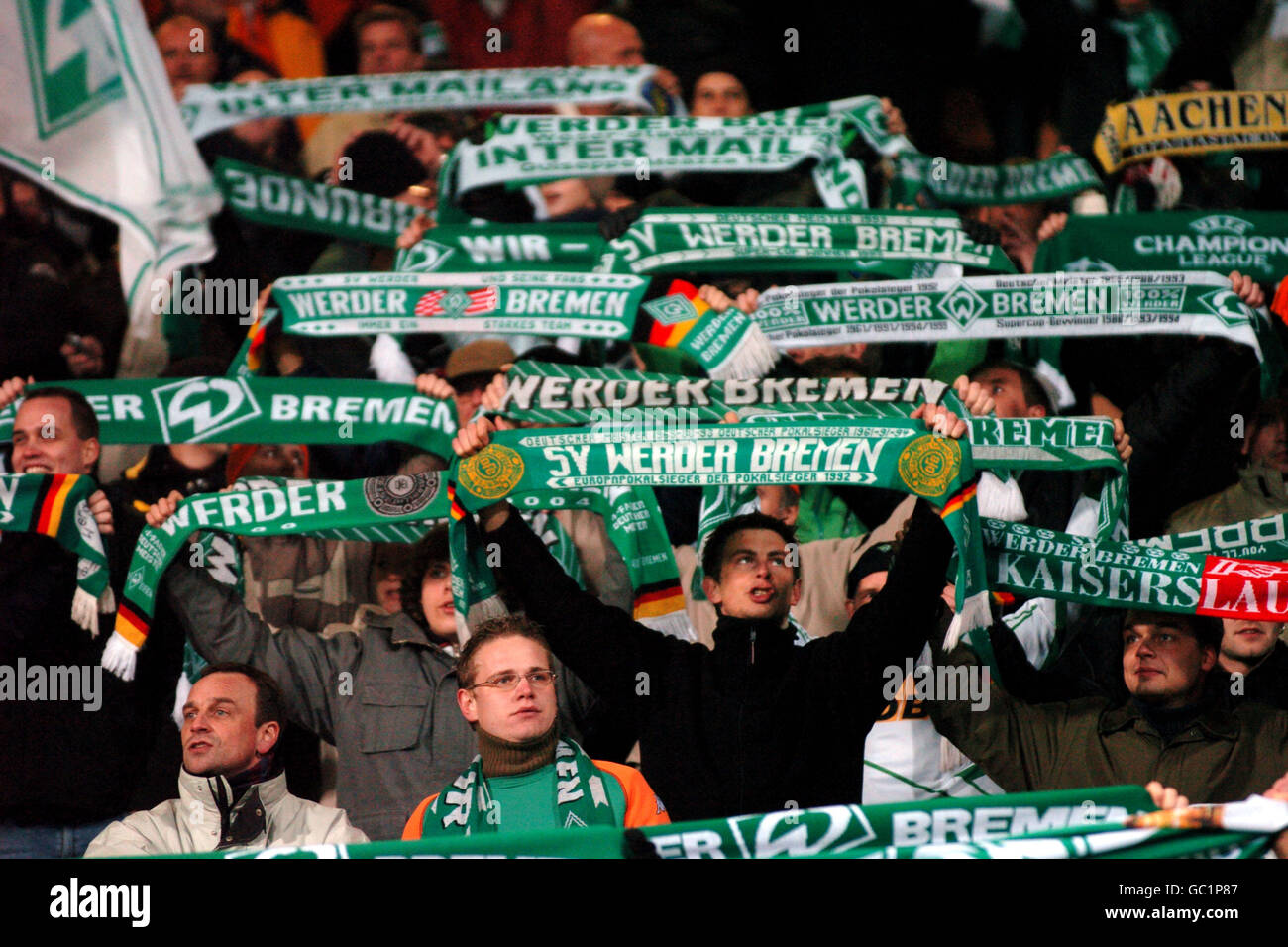 Fans of Ferencvarosi show their support as they hold scarves prior