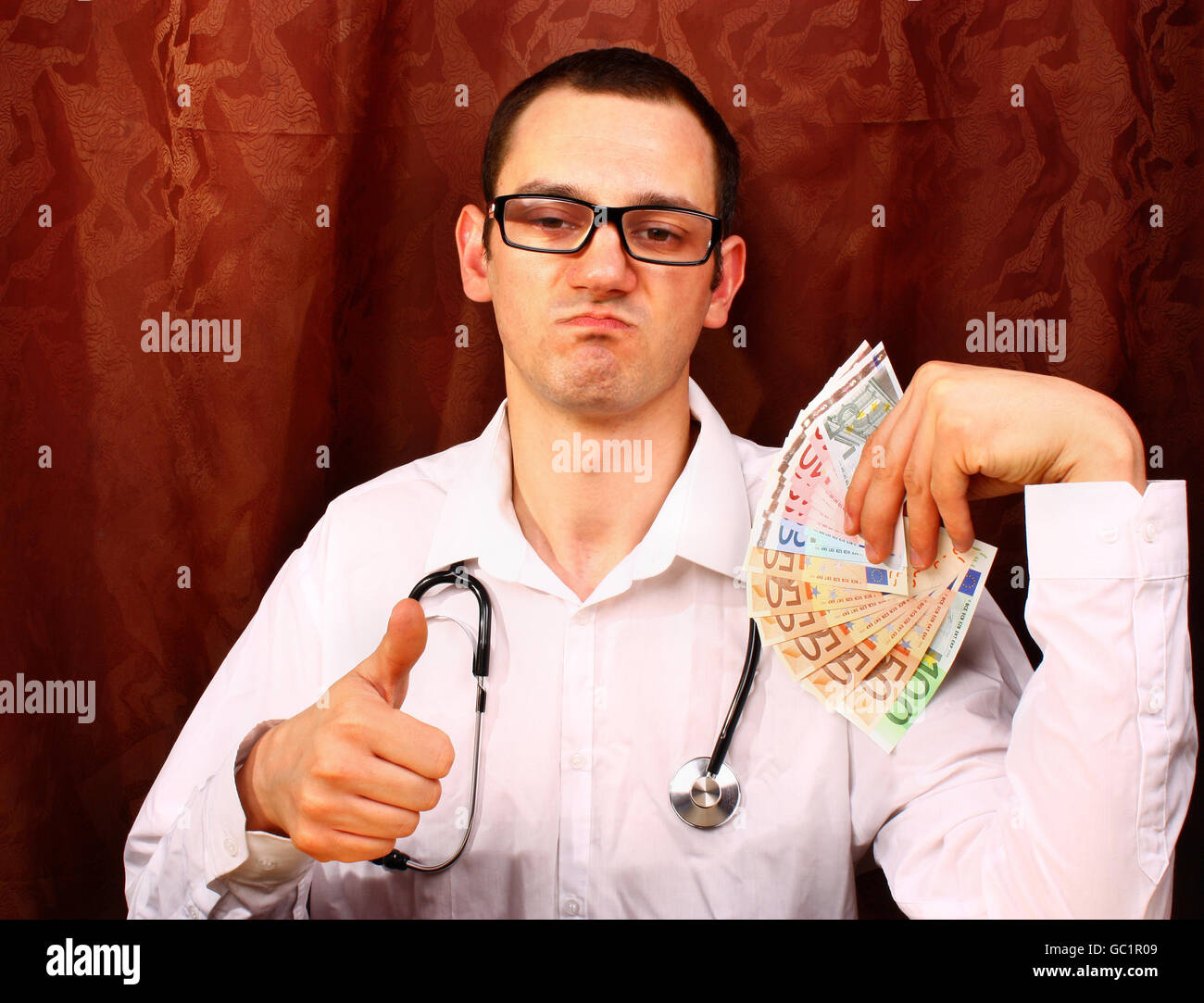 Male young doctor shows gesture thumbs up Stock Photo - Alamy