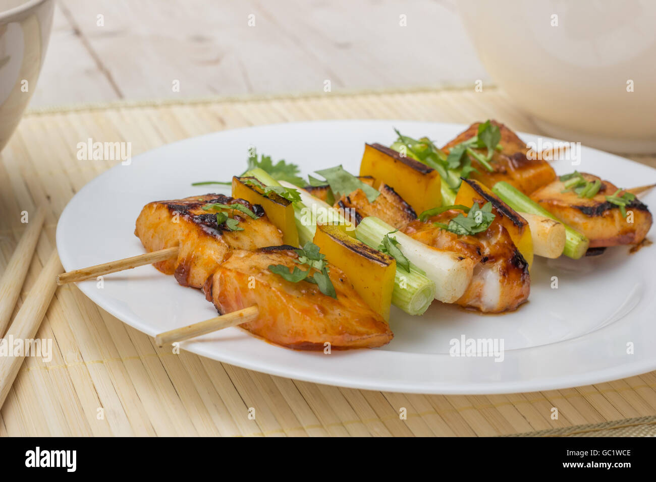 Asian tilapia filet on a skewer, served with rice Stock Photo Alamy