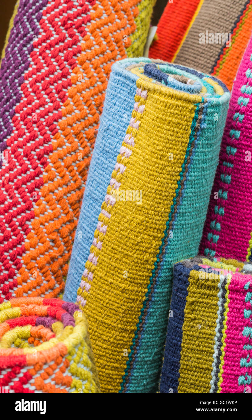 Rolled up indian carpets in different colors Stock Photo