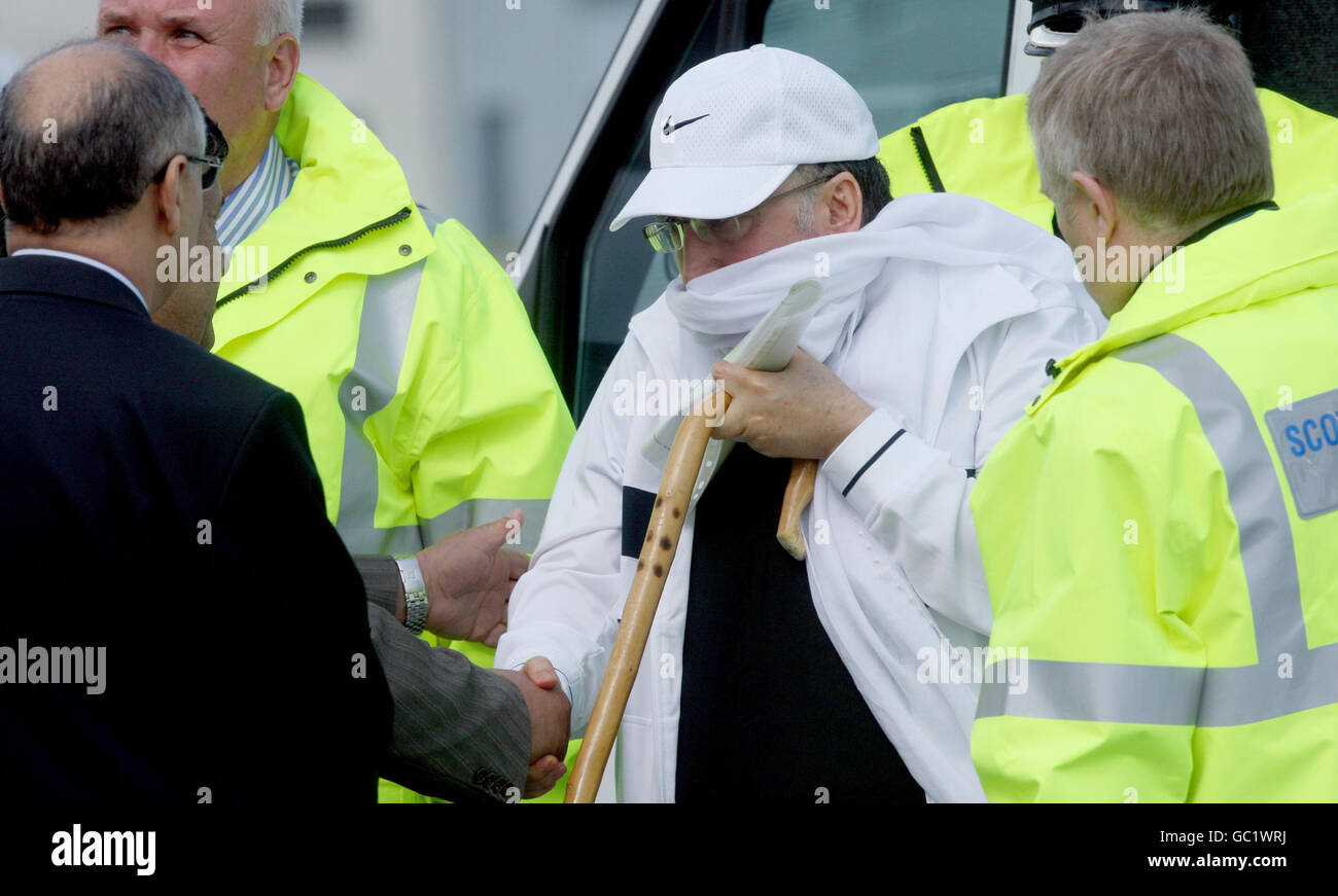 Lockerbie bomber Abdelbaset Ali Mohmed Al Megrahi leaves a police van before he boards a plane at Glasgow Airport, bound for Tripoli, after he was released on compassionate grounds by Scottish Justice Secretary Kenny MacAskill. Stock Photo