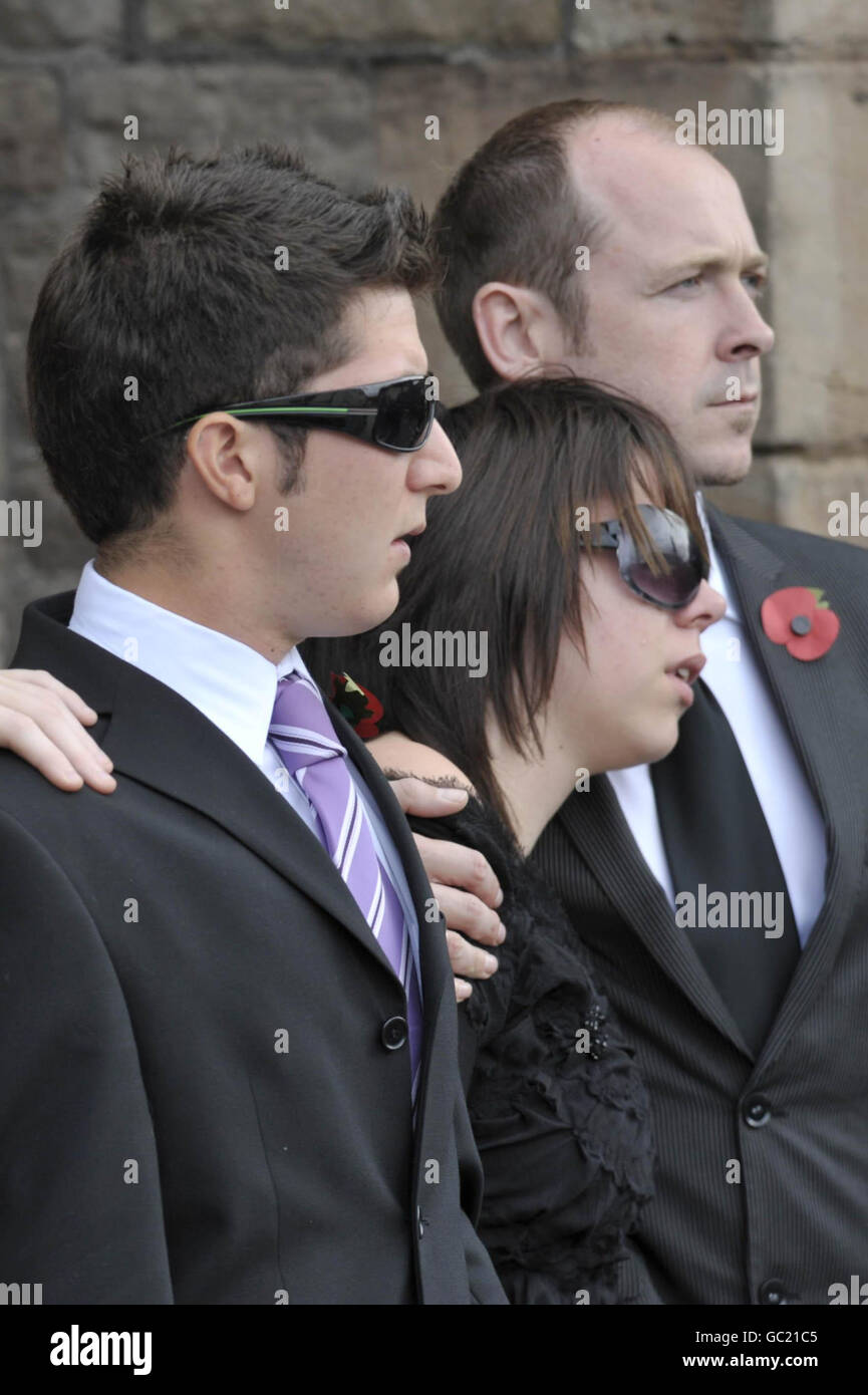 RETRANSMITTED WITH ADDITIONAL CAPTION INFORMATION Jonathan Cholakian, 21, best friends to Richard Hunt, the 200th soldier to die in Afghanistan, and Richard's sister Fiona and brother Alun watch as Richard's coffin arrives Saint Mary's Priory Church, Abergavenny, Wales, where the funeral of Richard is taking place. Stock Photo