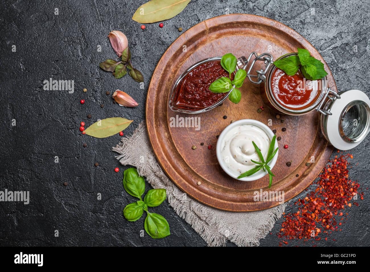 Various dip sauces on black background, top view Stock Photo - Alamy