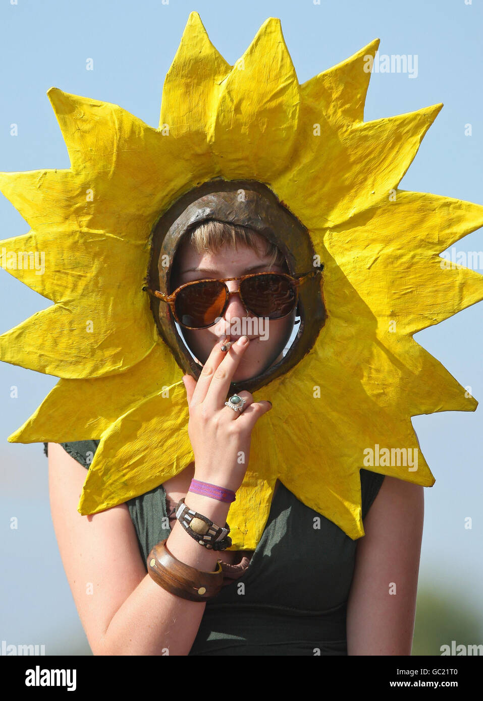 A protester dressed as a sunflower smokes at the climate camp, on Blackheath, in south east London. Stock Photo