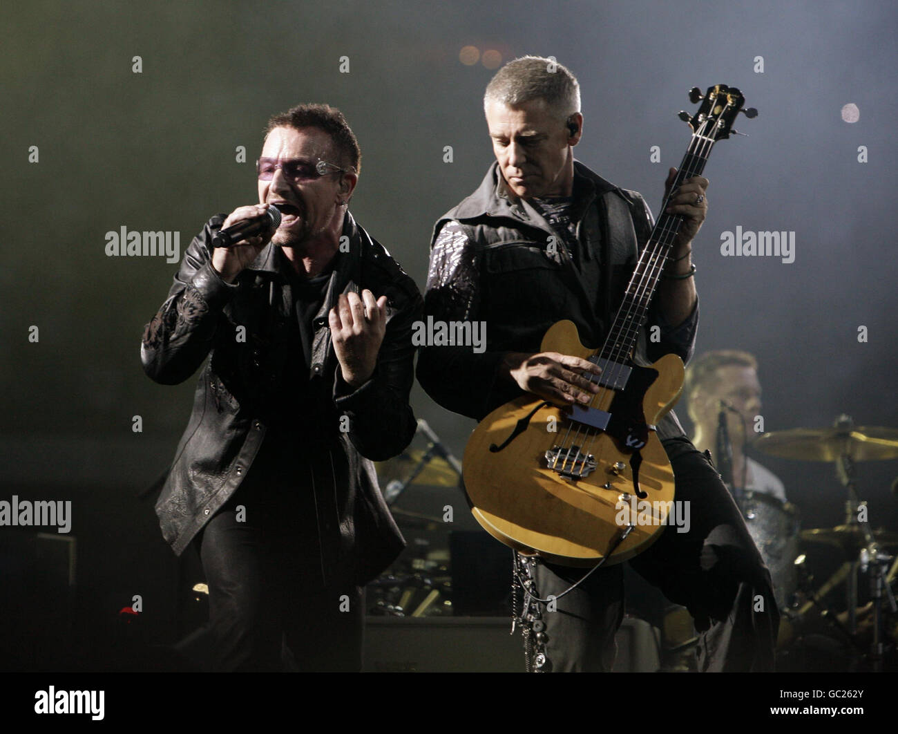 U2 perform at Wembley Stadium - London. Bono (left) and Adam Clayton of U2 performing at Wembley Stadium in north London. Stock Photo