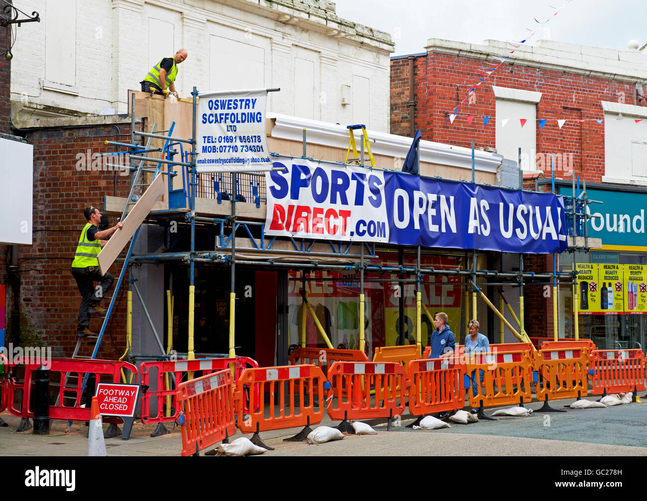 Workmen renovating Sports Direct store in Oswestry, Shropshire, England UK Stock Photo
