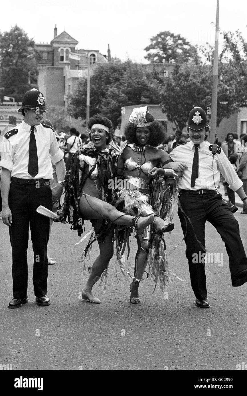 Police constable John Corbett joins an impromptu knees-up with Notting Hill Carnival revellers. PC Corbett, of Harrow Road police station, found his can-can partners on the second day of the August Bank holiday festival. Stock Photo