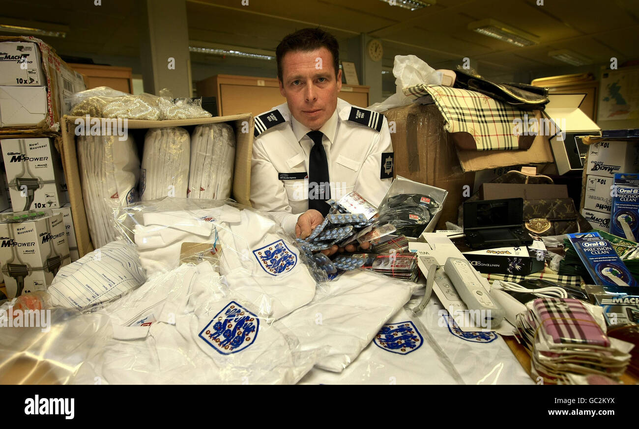 UK Border Agency Operations Manager Chris Bagley shows some of the 1.6M of counterfeit goods seized at East Midlands airport in just four months. Stock Photo
