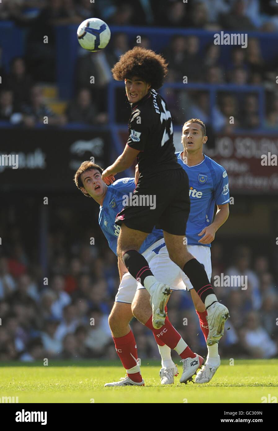 Everton's Marouane Fellaini (centre) in action as Portsmouth's Marc Wilson (left) and Hassan Yebda (right) look on Stock Photo