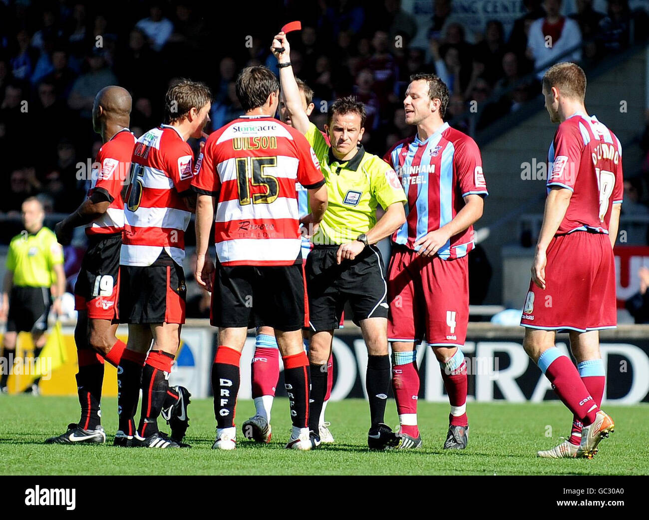 Doncaster Rovers' John Oster is shown a red card by referee Mr Keith